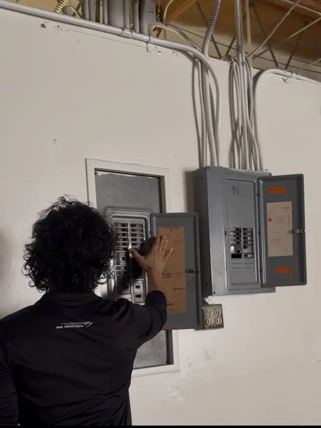 Nathan Barboza Garcia, owner of BNG Industries, working on an electrical panel